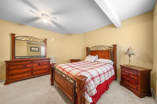 carpeted bedroom with beam ceiling, visible vents, and ceiling fan