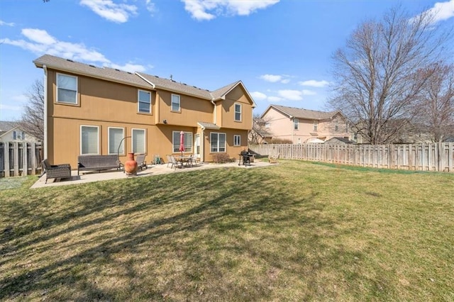 back of property featuring a yard, a fenced backyard, and a patio