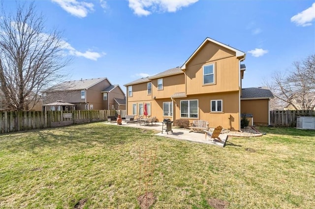 rear view of house with a fenced backyard, an outdoor fire pit, a yard, a residential view, and a patio area