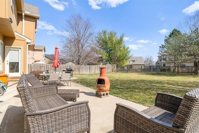 view of patio with outdoor dining area, a fenced backyard, and grilling area