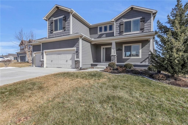 craftsman house featuring a garage, driveway, and a front lawn