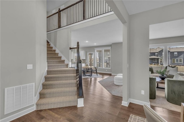 entryway featuring recessed lighting, visible vents, stairway, wood finished floors, and baseboards