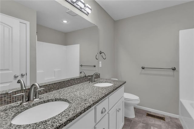 bathroom featuring toilet, baseboards, visible vents, and a sink