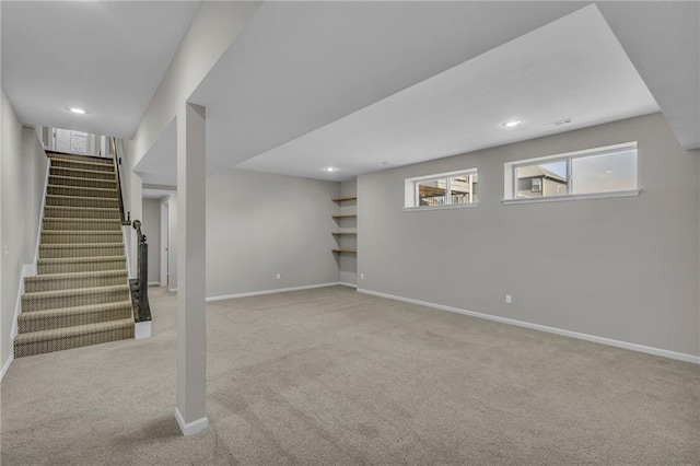 basement featuring light carpet, stairway, recessed lighting, and baseboards