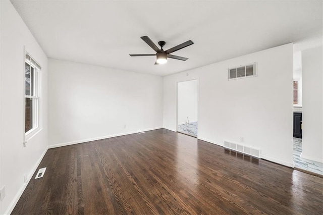 unfurnished room with ceiling fan and dark hardwood / wood-style floors