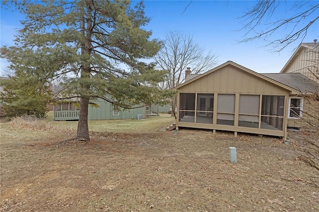 back of property with a sunroom