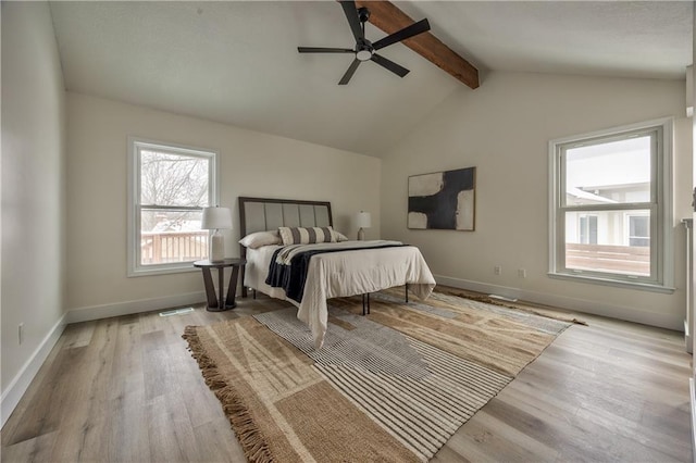 bedroom featuring ceiling fan, lofted ceiling with beams, and light hardwood / wood-style flooring