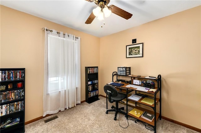 carpeted office with a ceiling fan, baseboards, and visible vents