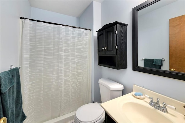 bathroom featuring vanity, toilet, and a shower with shower curtain