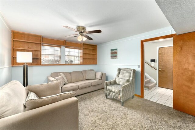 living room with tile patterned floors, stairway, a ceiling fan, and carpet floors