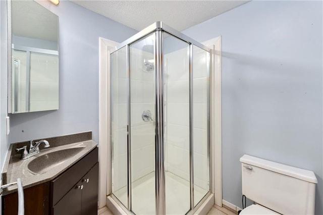 full bath featuring a stall shower, toilet, and vanity