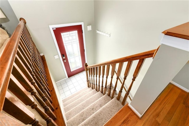 stairway featuring baseboards and wood finished floors