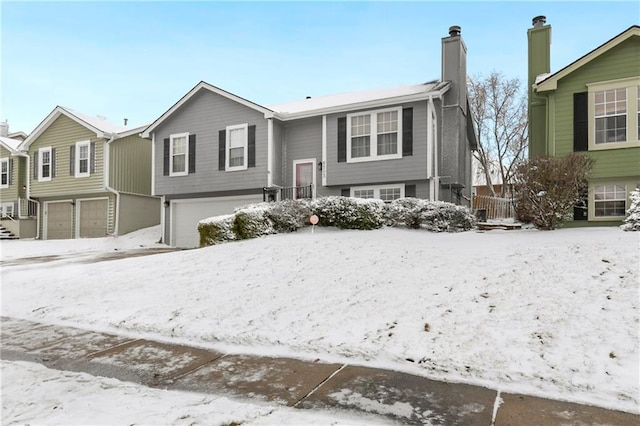 split foyer home with a chimney and a garage