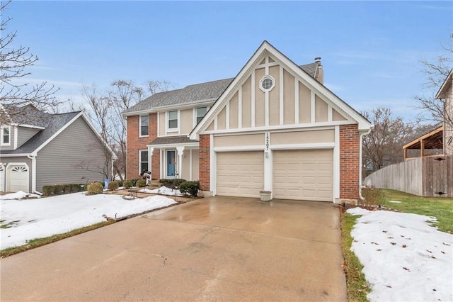 tudor-style house featuring a garage