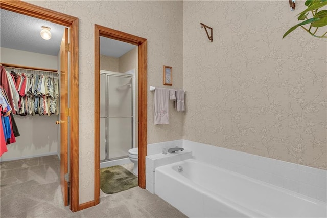 bathroom featuring toilet, shower with separate bathtub, and a textured ceiling