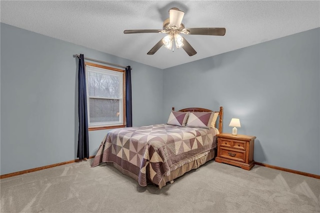 bedroom featuring ceiling fan, light carpet, and a textured ceiling