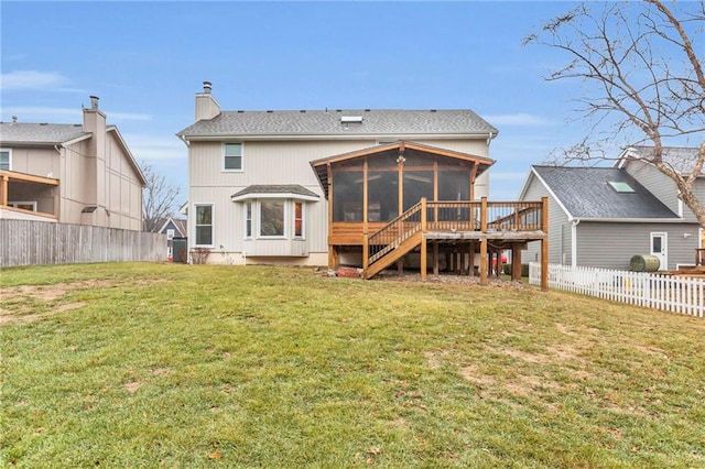 rear view of property with a sunroom and a lawn