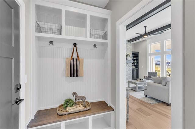 mudroom featuring beam ceiling, ceiling fan, and light wood-type flooring