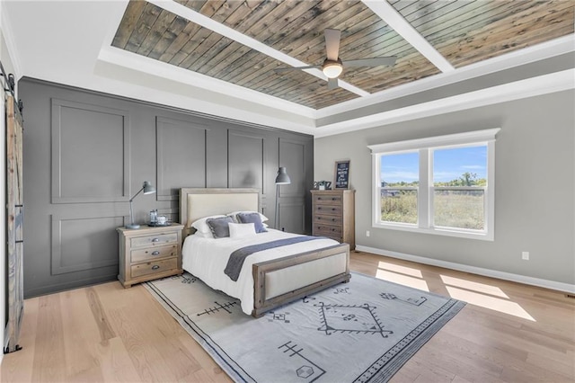 bedroom with wood ceiling, ceiling fan, ornamental molding, light hardwood / wood-style floors, and a raised ceiling