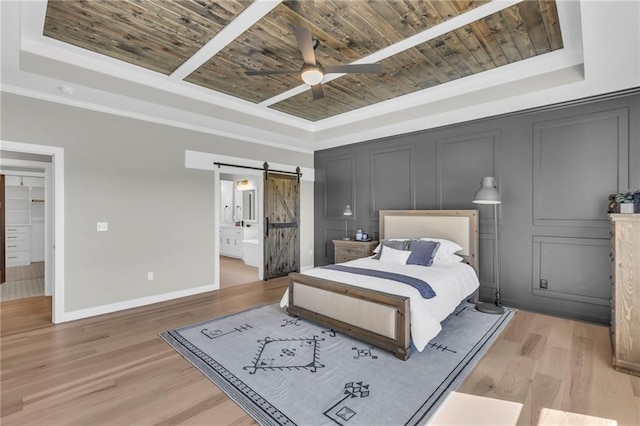 bedroom with hardwood / wood-style floors, a tray ceiling, wooden ceiling, and a barn door