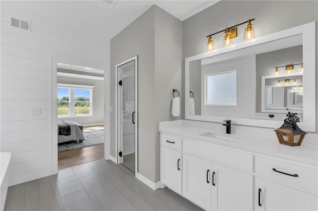 bathroom featuring vanity and a shower with door