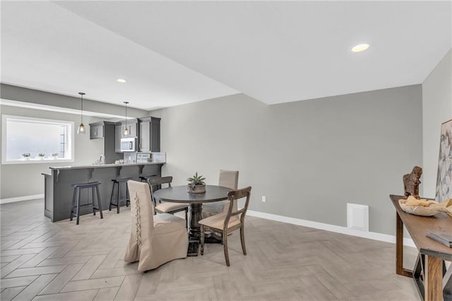 dining area featuring light parquet floors