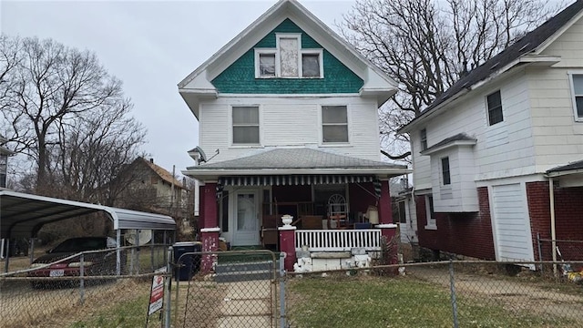 victorian-style house with a porch and a carport