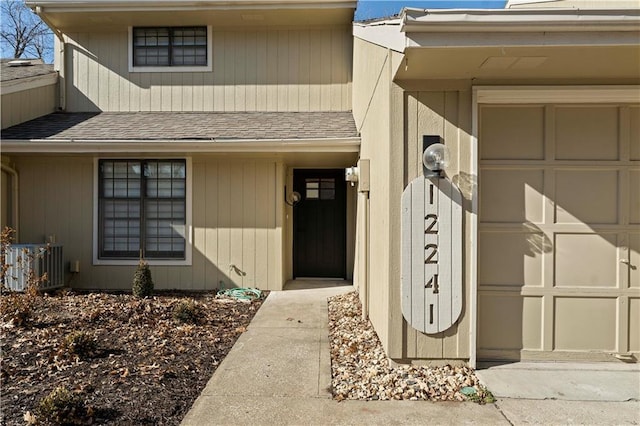 doorway to property with a garage