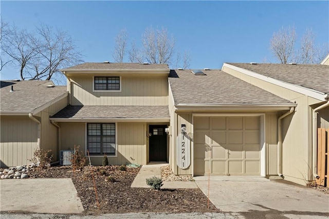 view of front of house with central AC unit and a garage