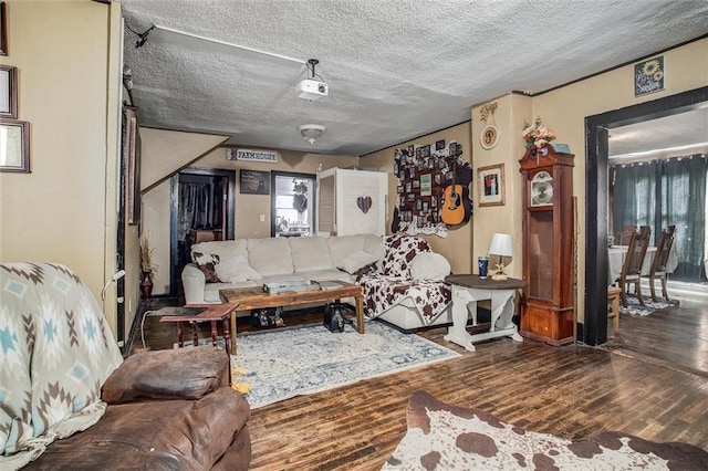 living area with a textured ceiling and wood finished floors