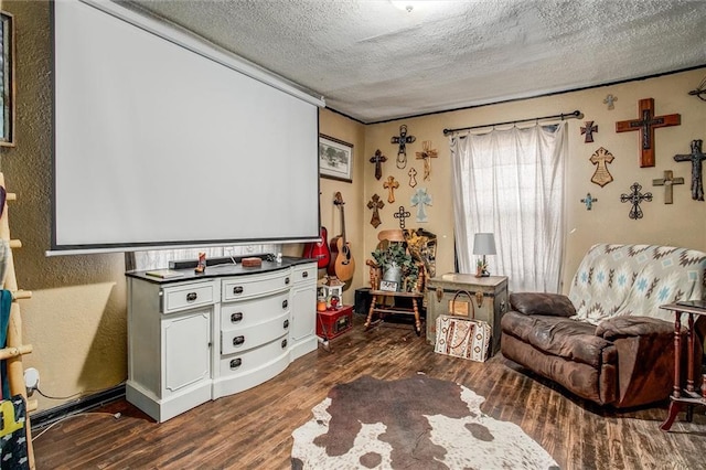 game room with a textured ceiling and dark wood finished floors