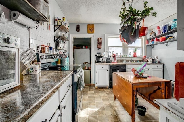 kitchen with black dishwasher, stainless steel electric range oven, white cabinetry, and open shelves