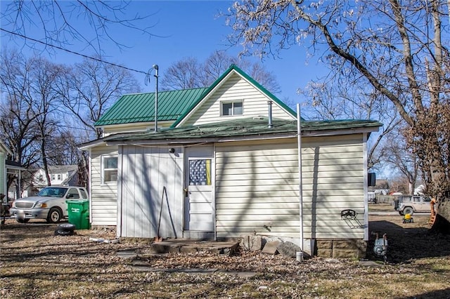 rear view of house featuring metal roof