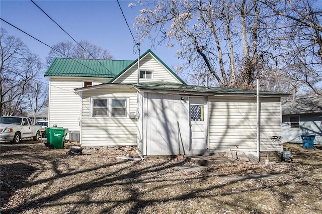 back of house with metal roof