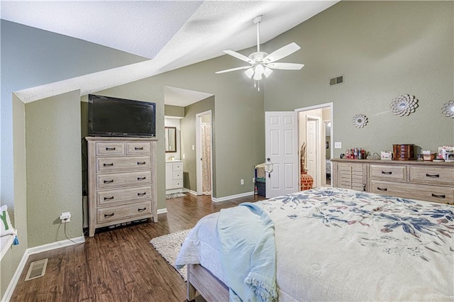 5933 Ridgeway Ave, Kansas City, MO 64133 - bedroom with dark wood-style floors, lofted ceiling, visible vents, and baseboards