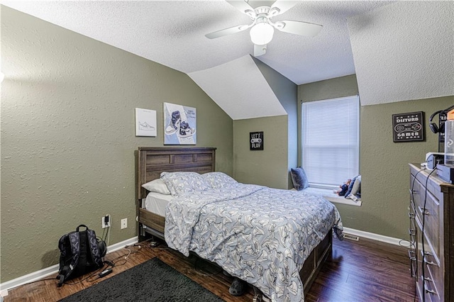 5933 Ridgeway Ave, Kansas City, MO 64133 - bedroom featuring dark wood-style floors, a textured wall, and baseboards