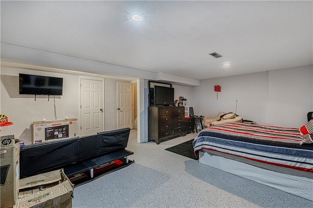 5933 Ridgeway Ave, Kansas City, MO 64133 - bedroom with a textured ceiling, speckled floor, and visible vents