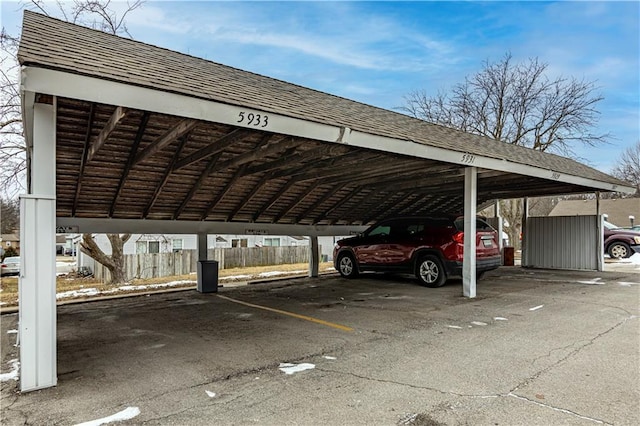 5933 Ridgeway Ave, Kansas City, MO 64133 - covered parking lot featuring fence