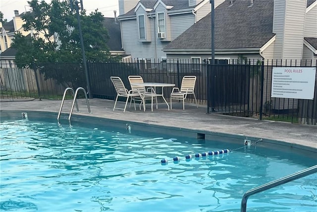 5933 Ridgeway Ave, Kansas City, MO 64133 - pool featuring fence and a patio