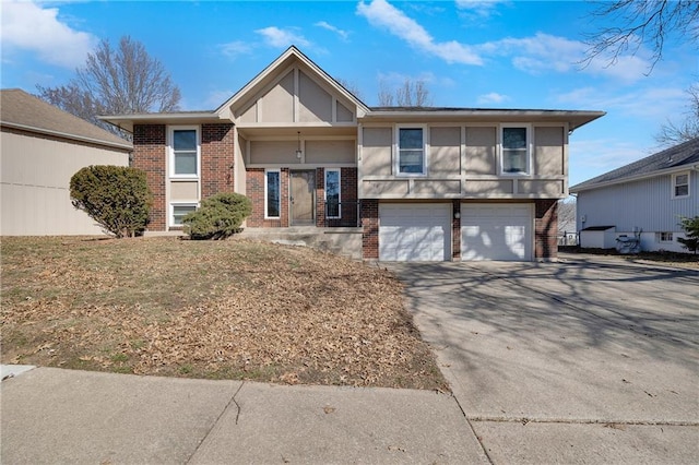 view of front facade with driveway, brick siding, and an attached garage