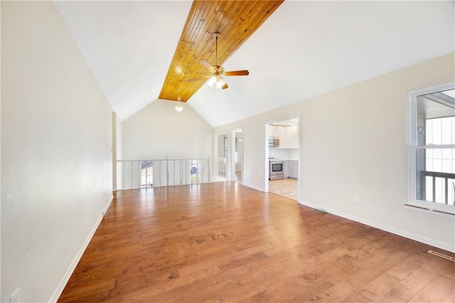 unfurnished living room with visible vents, baseboards, ceiling fan, wood finished floors, and high vaulted ceiling