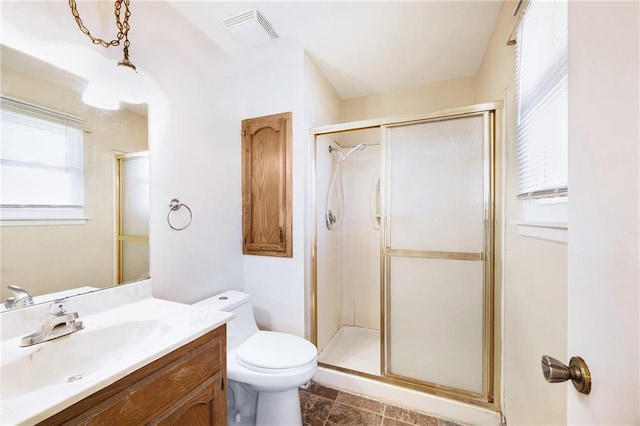 bathroom with visible vents, a shower stall, toilet, and vanity