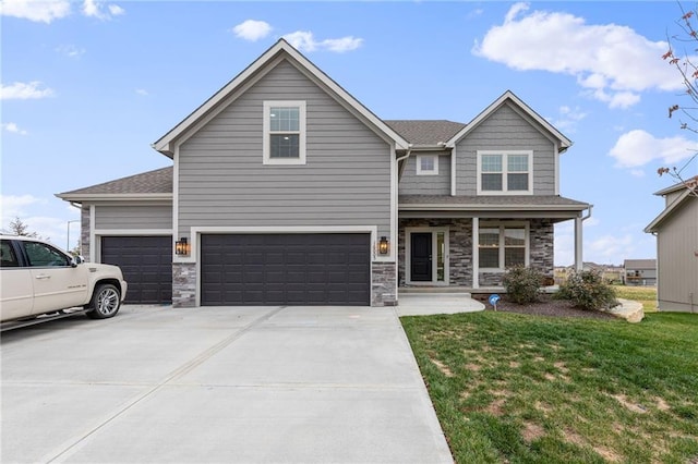 view of front of property with a porch, a garage, and a front yard