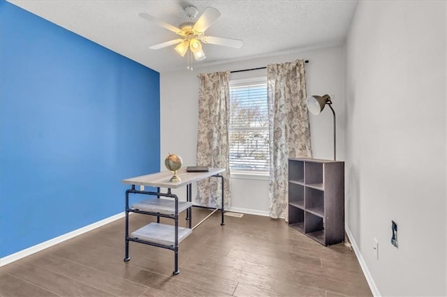 office with a ceiling fan, a textured ceiling, baseboards, and wood finished floors