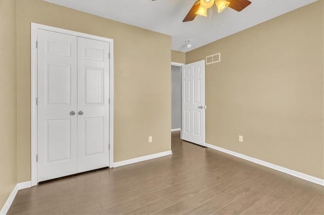 unfurnished bedroom featuring baseboards and wood finished floors