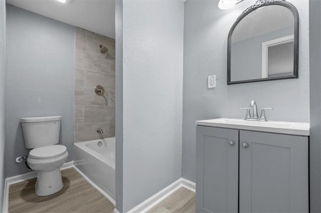 1111 Main St, Osawatomie, KS 66064 - bathroom featuring wood finished floors, vanity, and washtub / shower combination