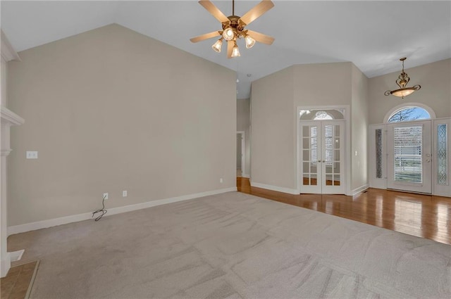 interior space with a ceiling fan, baseboards, high vaulted ceiling, french doors, and carpet flooring