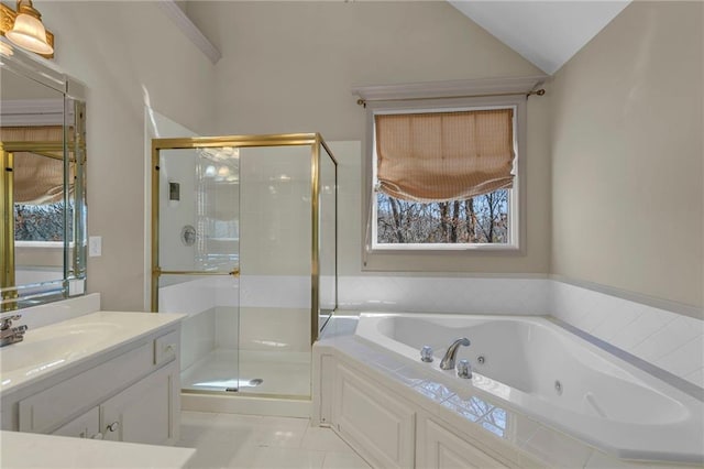 full bath with vanity, a tub with jets, a shower stall, and vaulted ceiling