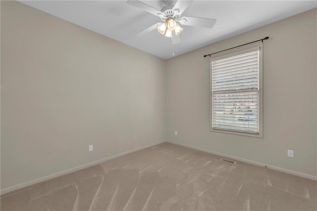 unfurnished room featuring baseboards, light carpet, visible vents, and a ceiling fan