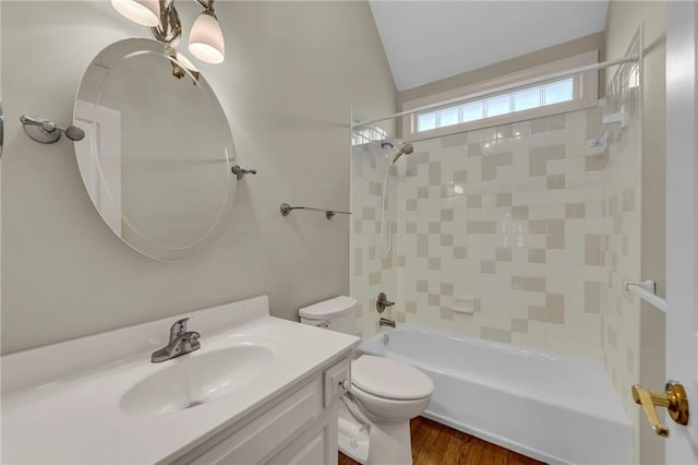 full bath with vanity, shower / tub combination, toilet, and lofted ceiling